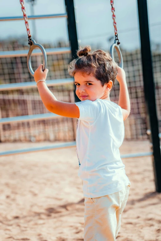 a child on a swing holding onto an object