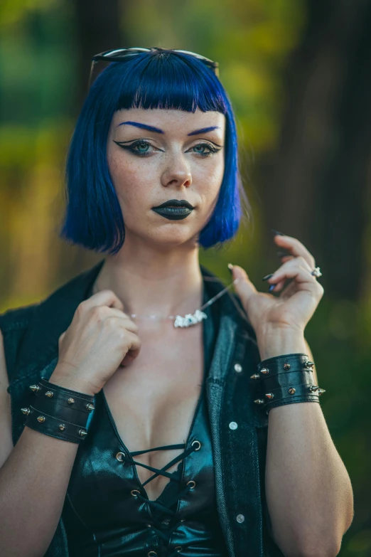 a woman with blue hair is smoking on a cigarette