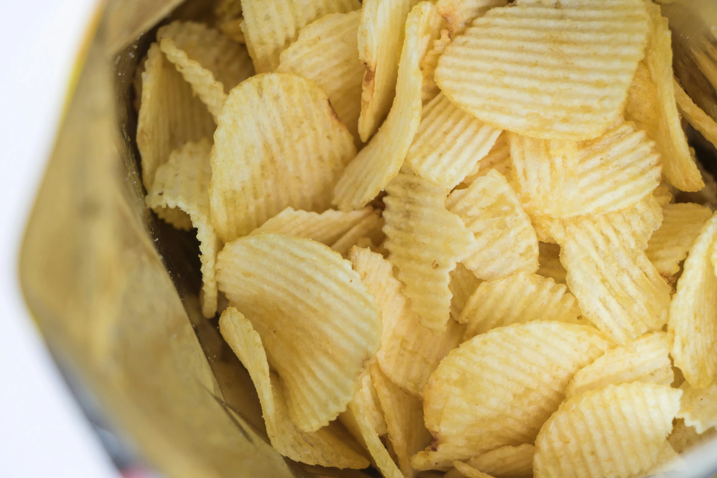 a close up of a metallic bowl with chips