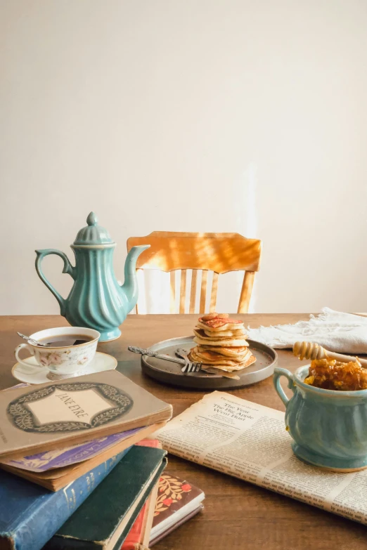 a wooden table topped with plates and bowls of food