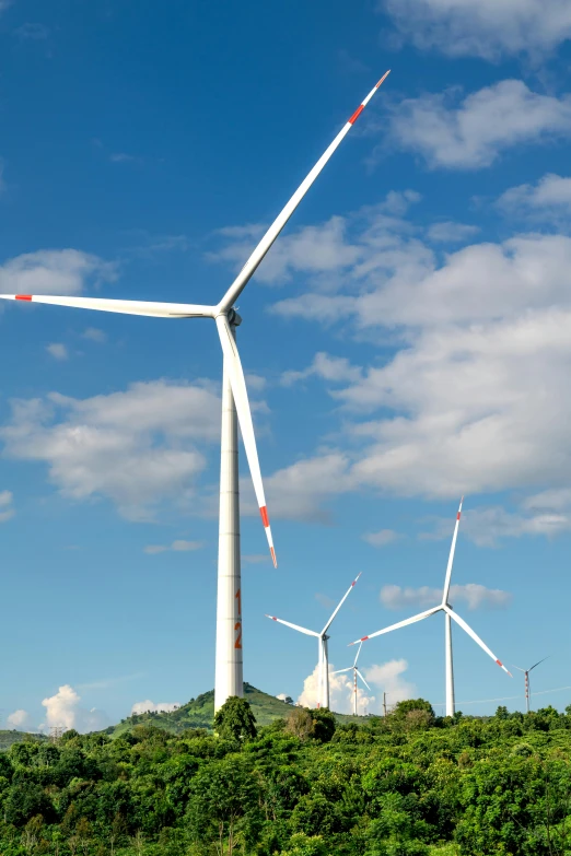 several wind turbines standing next to each other on top of a field