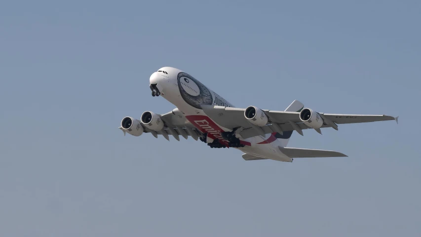 an airplane in the air with its landing gear down