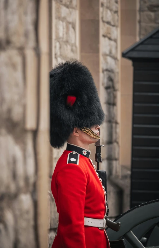 a person dressed in red uniform with a gun