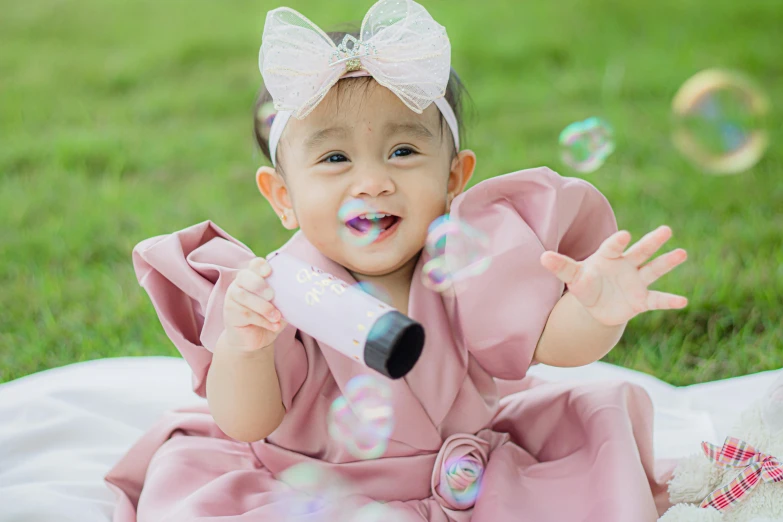 a little girl that is playing with bubbles