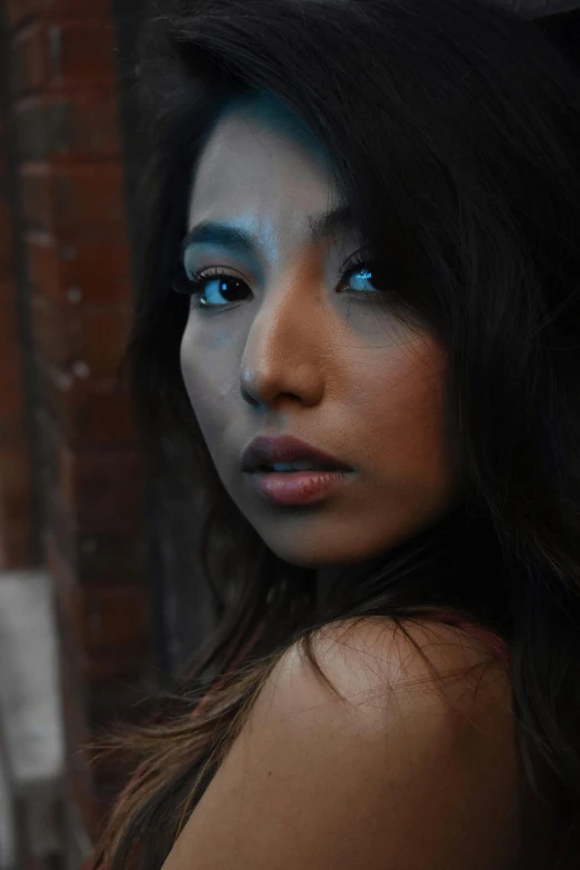 a woman with makeup painted like native americans looking off into the distance