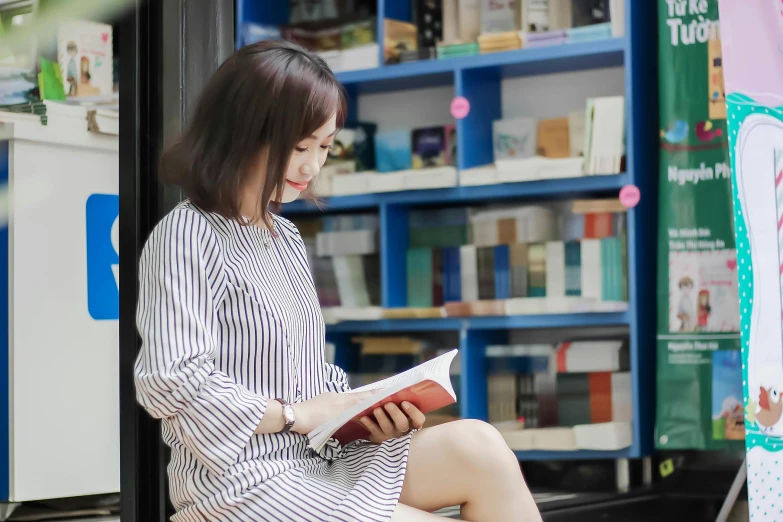 a woman sitting on the ground with books