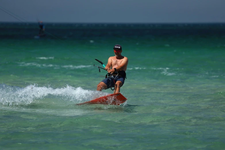 a man is standing on a surfboard and riding a wave