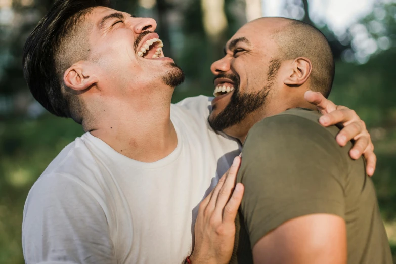 two guys sharing a hug in the woods