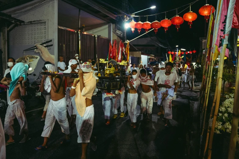 group of men walking down the street during a festival