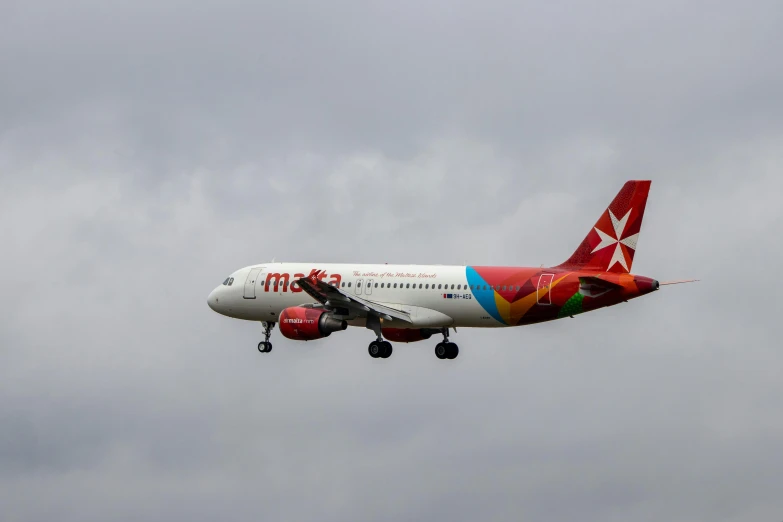 an airplane in the air on cloudy day