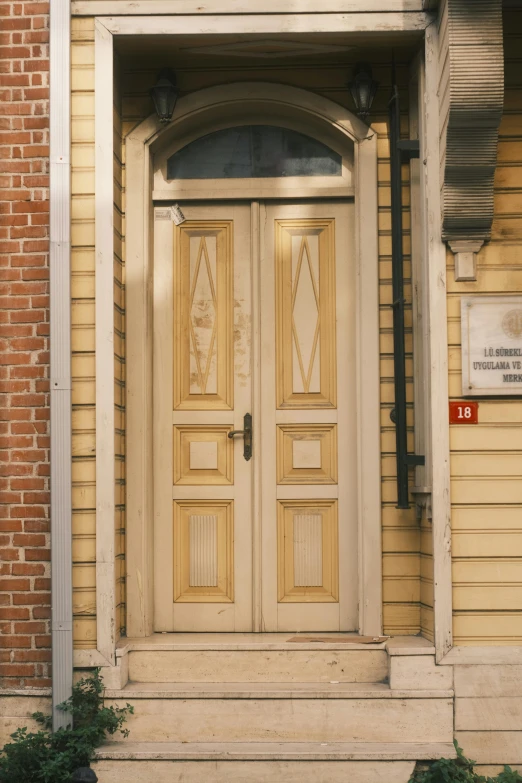 a building with two large doors and a brick porch