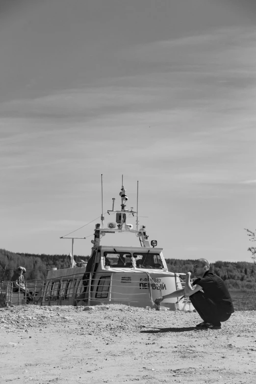 a boat is parked on the sandy shore