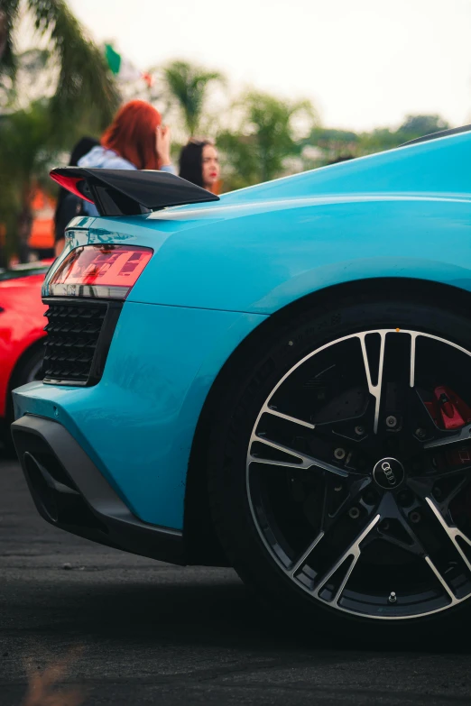 a blue sports car sitting on a parking lot