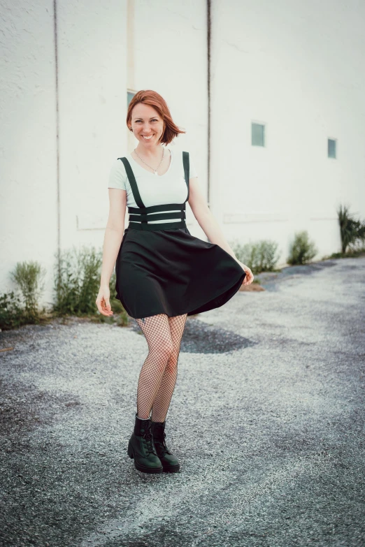 a woman is walking in the street dressed in black and white