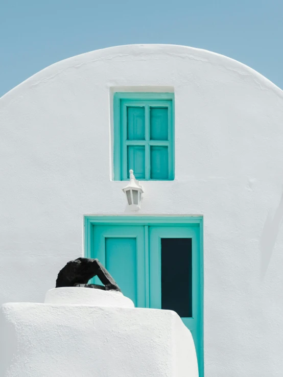 a woman standing on the steps outside of a building