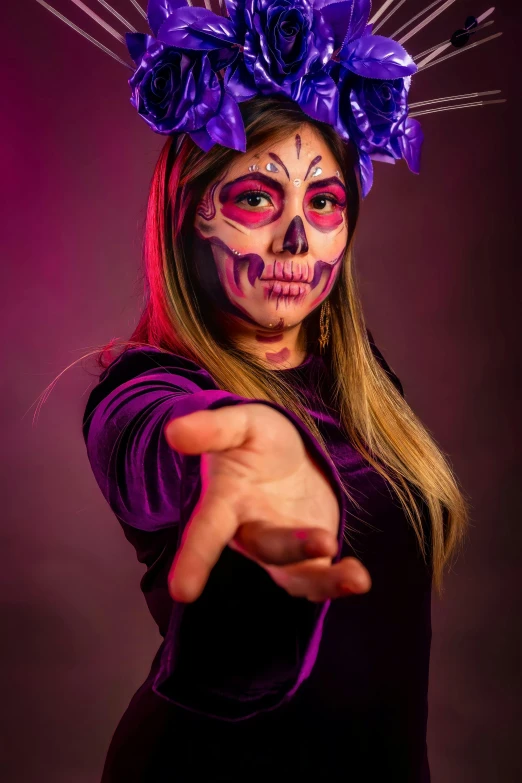 a woman with makeup on her face pointing at the camera