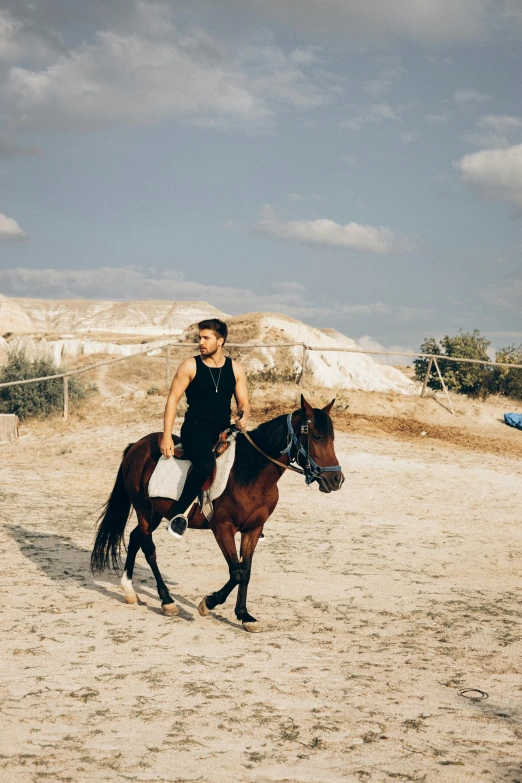 a person riding on the back of a brown horse