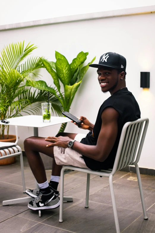 a man sitting in a chair with his feet up in a tablet