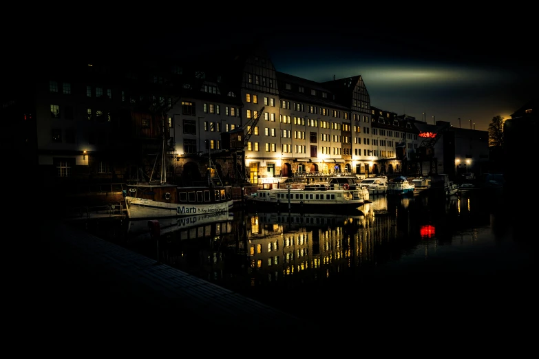 buildings reflect off the water as boat docks pass