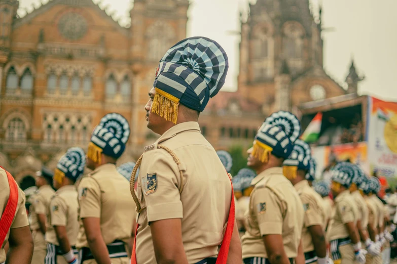 the men in uniforms are standing at attention