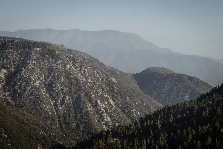 a group of mountains with trees in the foreground