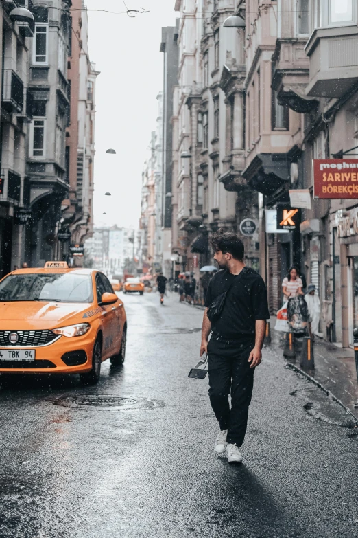 two men walking down a street next to some buildings