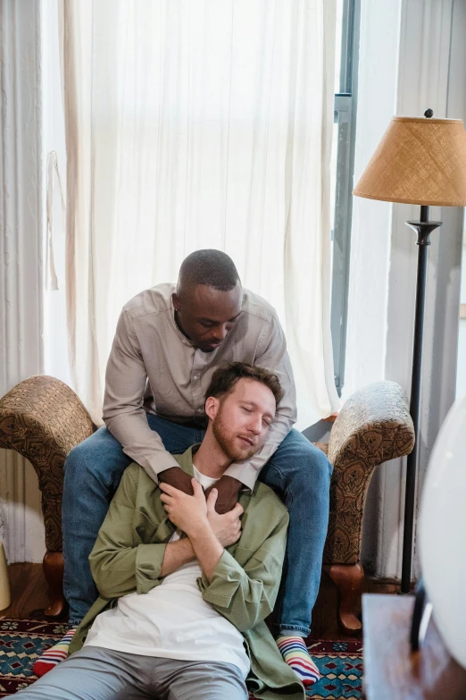 a couple of people sitting on top of a couch