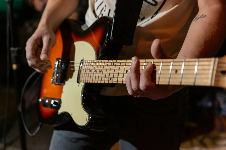 a person playing on an electric guitar at an event