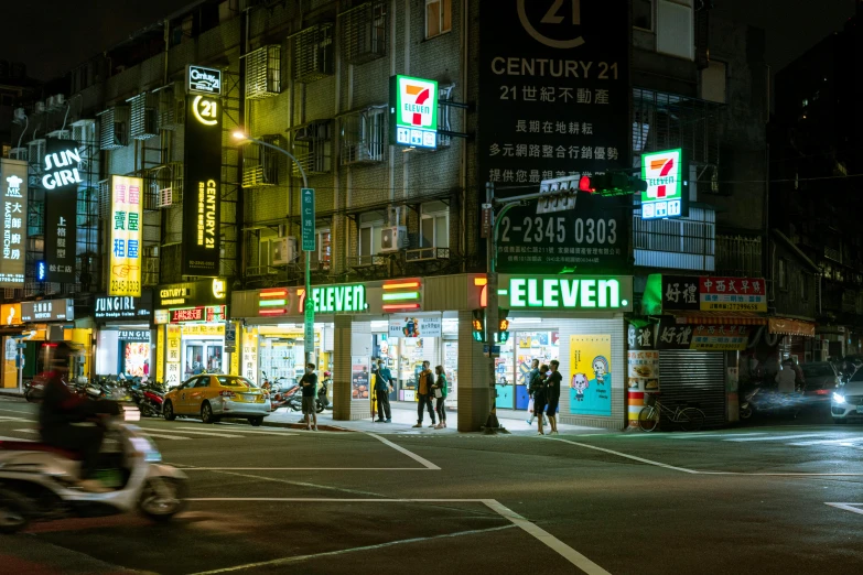 busy asian street corner at night with stores