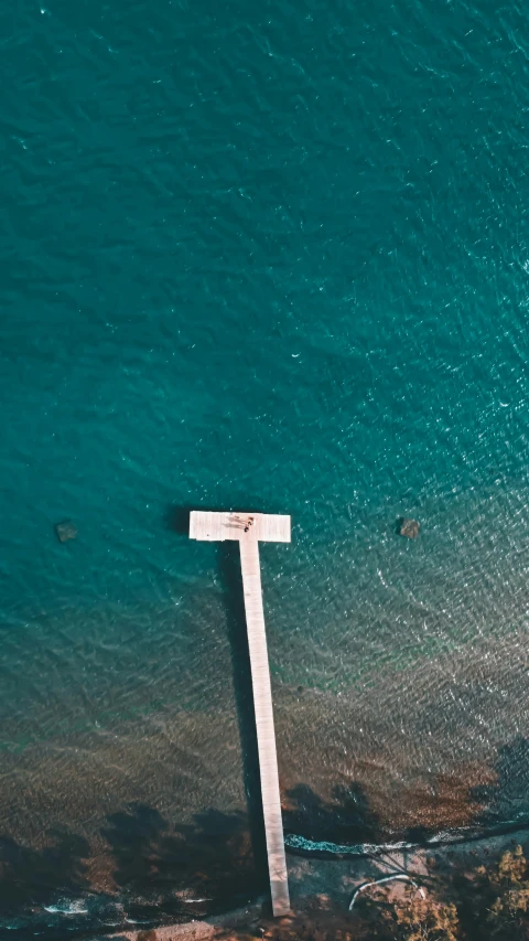 a large body of water with a cross sitting in it