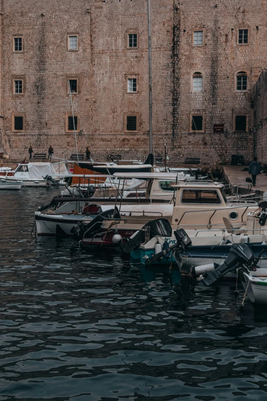 a harbor filled with lots of boats next to large buildings