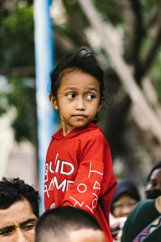 a little girl is on a group of people