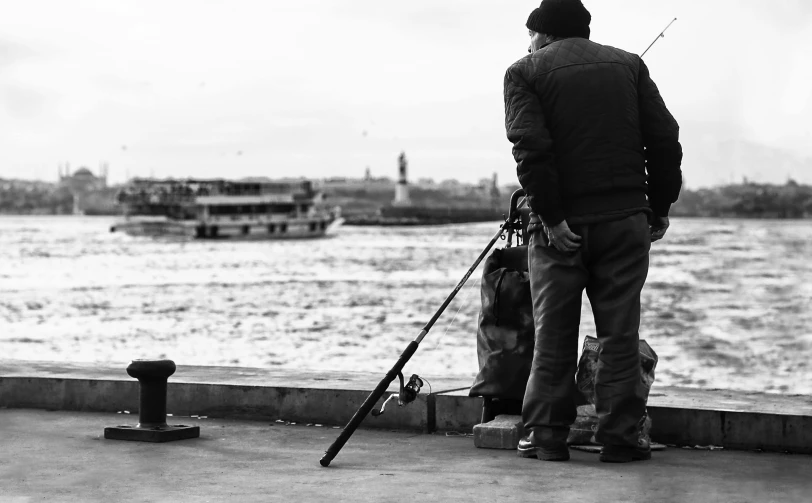 two guys looking at the water from a pier