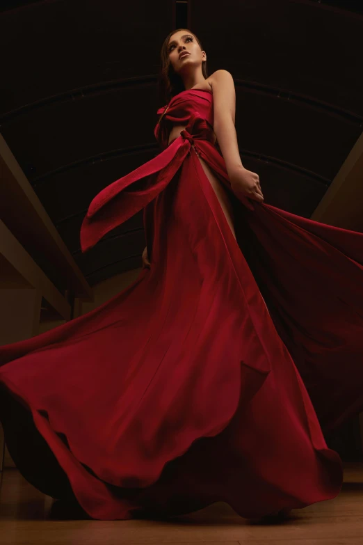 a woman wearing red and a flowing dress