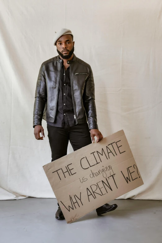 a person standing up with a sign in his hand