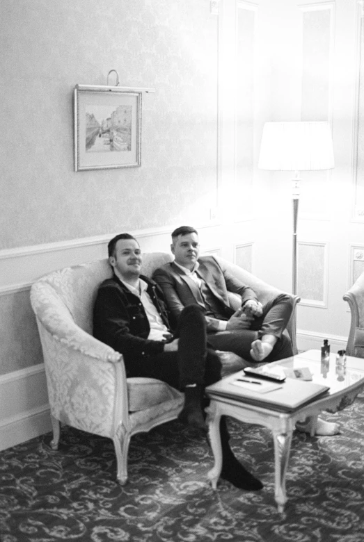 the two men sitting together in the living room