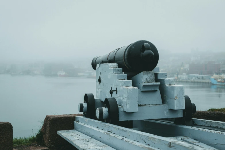 a cannon is attached to the side of a railing