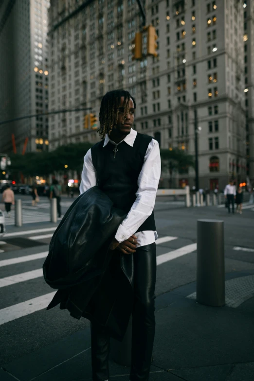 a person carrying a black bag across the street