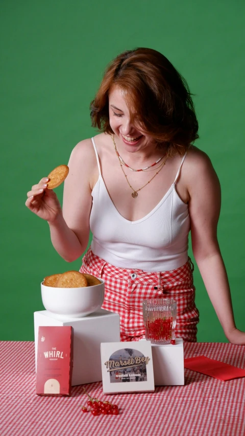 the woman is eating cookies and getting ready to serve them