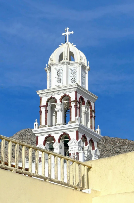 a building that is very tall with a cross on the top