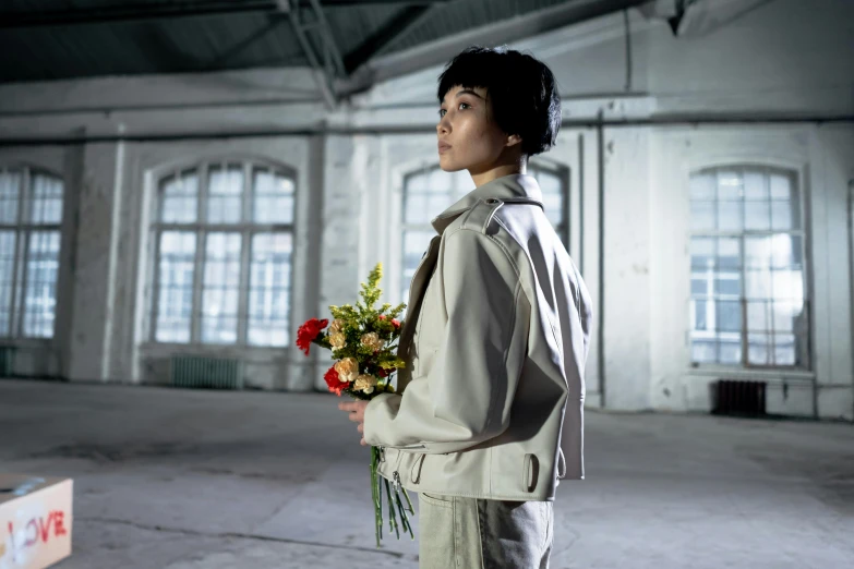 a person with flowers standing and looking up