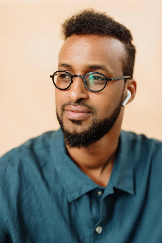 a man with glasses is staring at the camera