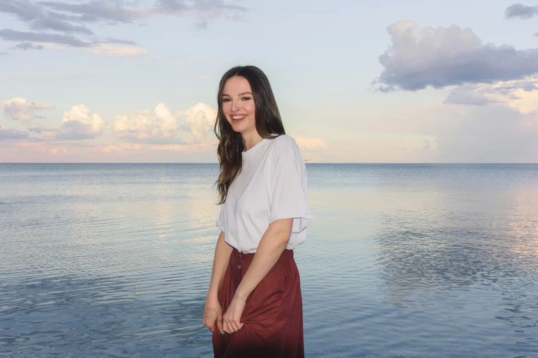 woman standing on the beach looking into camera