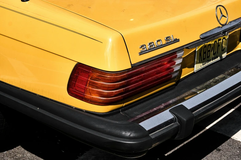 an image of the back of a yellow mercedes benz coupe