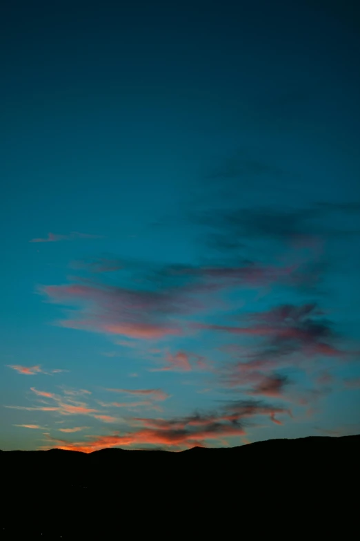 the silhouette of the airplane in flight at sunset