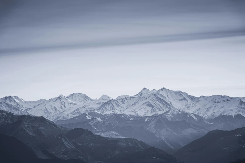 a black and white po of snow capped mountains