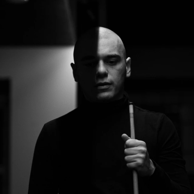 black and white po of a man holding a bat