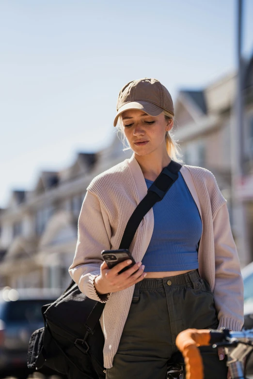 a young woman looking down at her cell phone