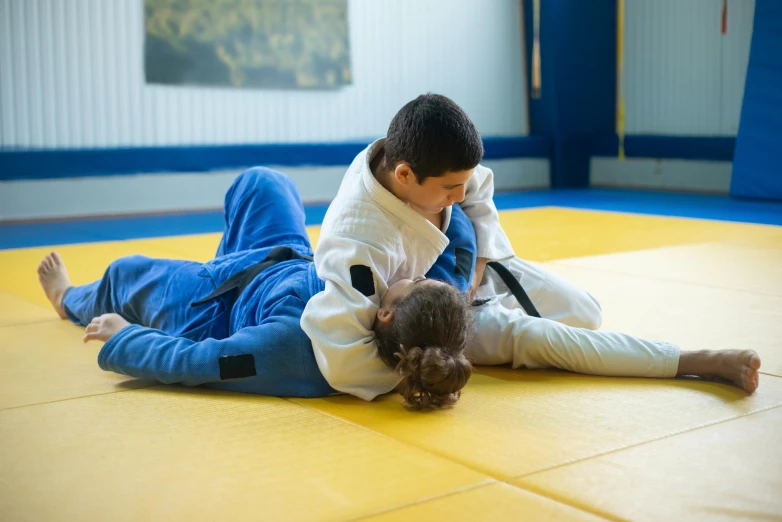 a man and girl are in action on the ground