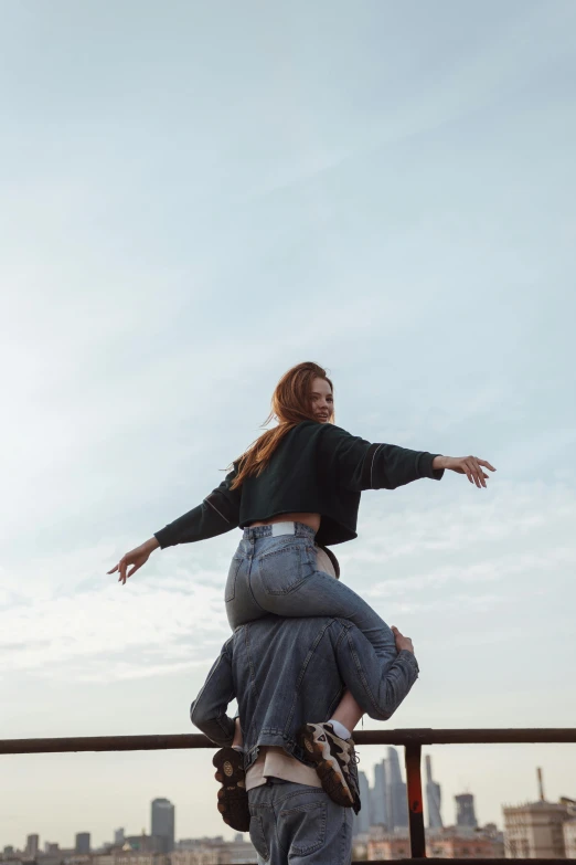 a young woman standing on top of another women's back